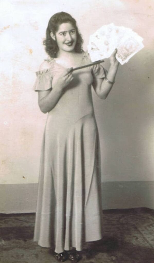 Fotografía antigua de una maga realizando un truco de magia con cartas