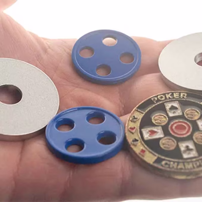 Conjunto de botones de latón edición plata y poker en una mano.